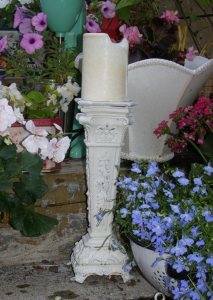 This white candle holder was an ugly gold iron lampbase. Painted white, it served as a beautiful centerpiece for my staircase container garden in summer